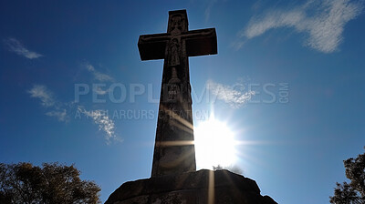 Low angle, stone or cross in blue sky church for religion, spirituality or Catholic faith. Ai generated statue, monument or symbol for Christianity prayer, calm or peace in hope or crucifixion belief