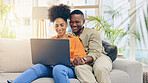 Laptop, couple smile and relax in home living room, bonding and online shopping on sofa. Interracial, computer and happy black man and woman on social media, internet browsing or streaming video.