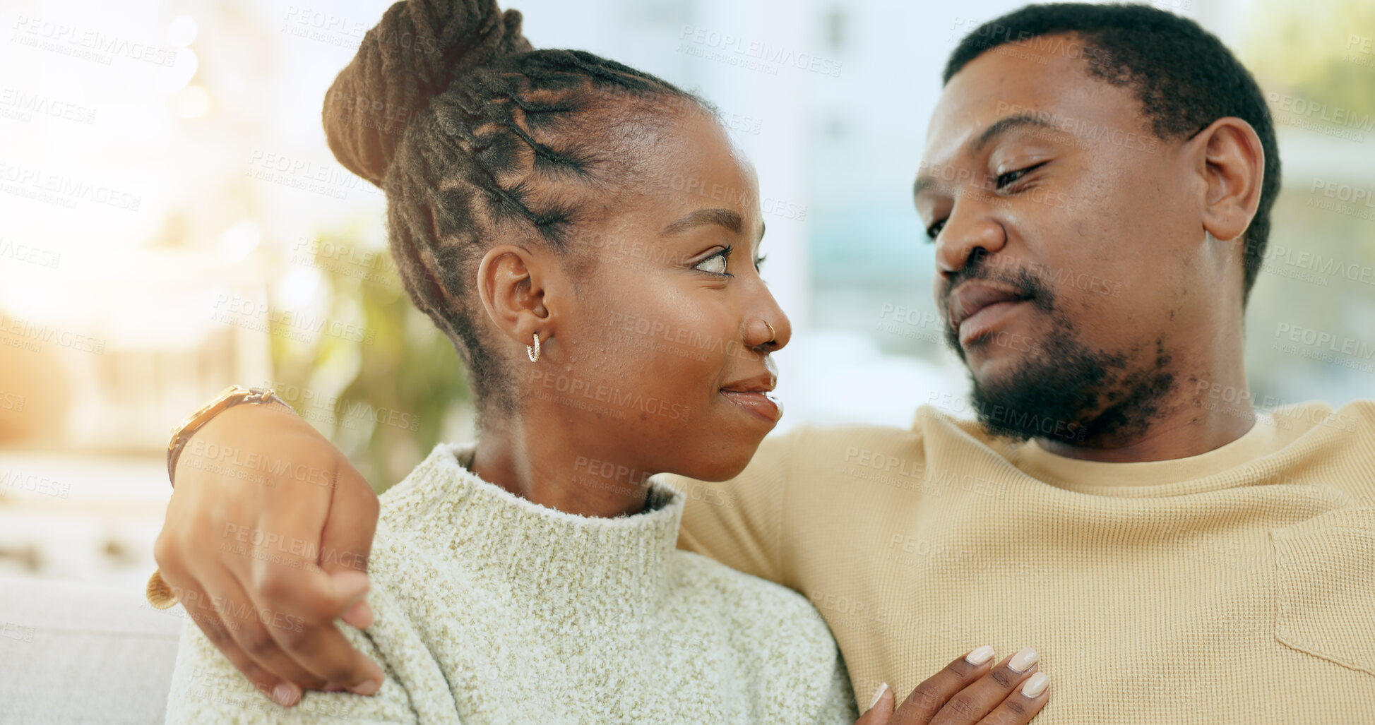 Buy stock photo Care, relax or black couple on couch in home or living room together with love, support or trust. Wellness, commitment or man with an African woman with bond, solidarity or eye contact in marriage