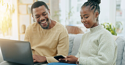 Buy stock photo Black couple, laptop and phone on sofa, laugh and funny video on website, social media or app in home. Happy African man, woman and smile together on lounge couch with computer, smartphone or reading