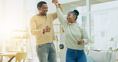 Buy stock photo African couple, dancing and home in living room, happy and holding hands for steps, celebration and freedom. Black woman, man and partnership, bonding and love with romance, smile and care in house