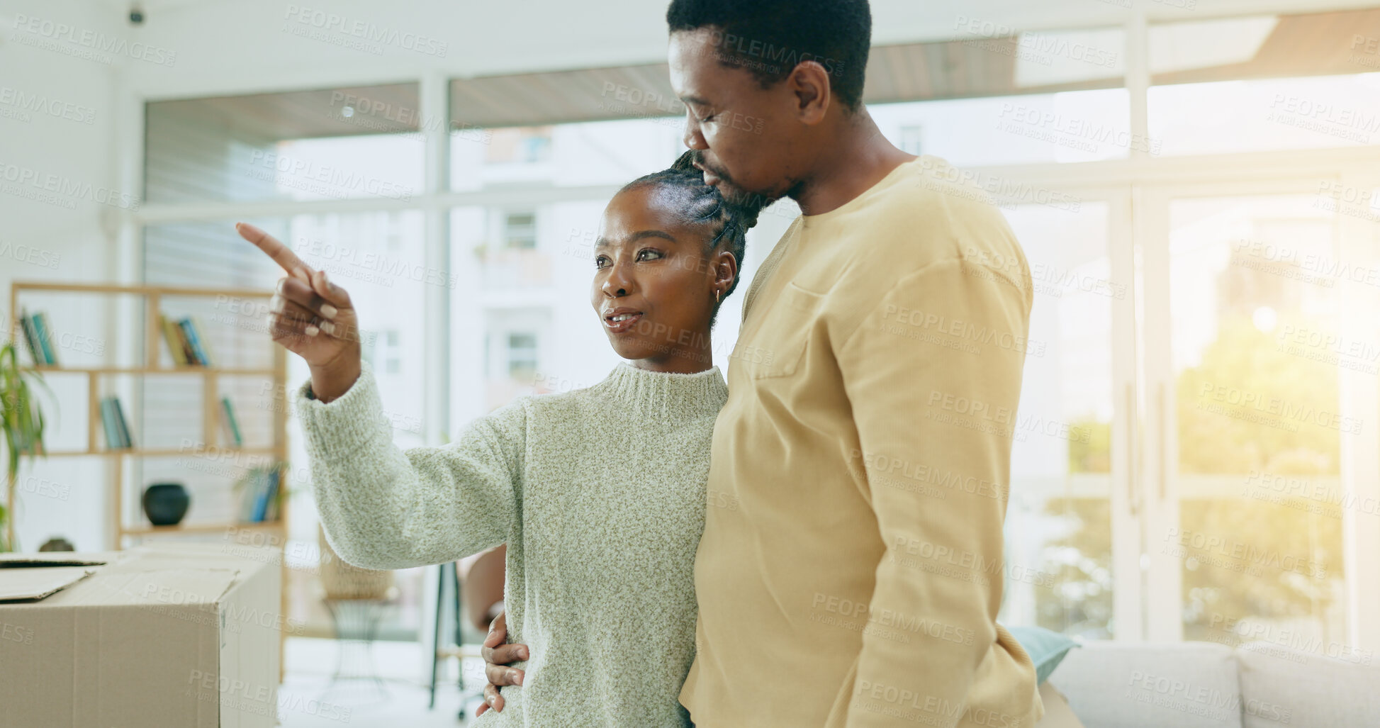 Buy stock photo African couple, pointing and new home with boxes, thinking and ideas with discussion, decision and choice. Black woman, man and sign for direction, moving or chat for real estate, property or house