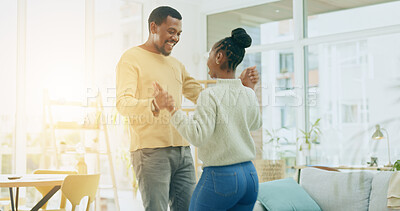 Buy stock photo Happy black couple, dancing and holding hands for love, support or bonding in living room at home. African man and woman smile in happiness or celebration for anniversary, weekend or holiday at house