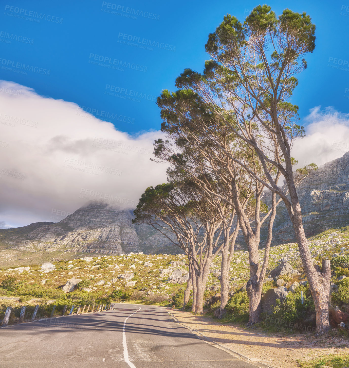 Buy stock photo Roadtrip through mountain view landscape on tar road or street with blue sky in summer in popular tourism destination. Travel on leading path to scenic, green hills for weekend exploring or driving