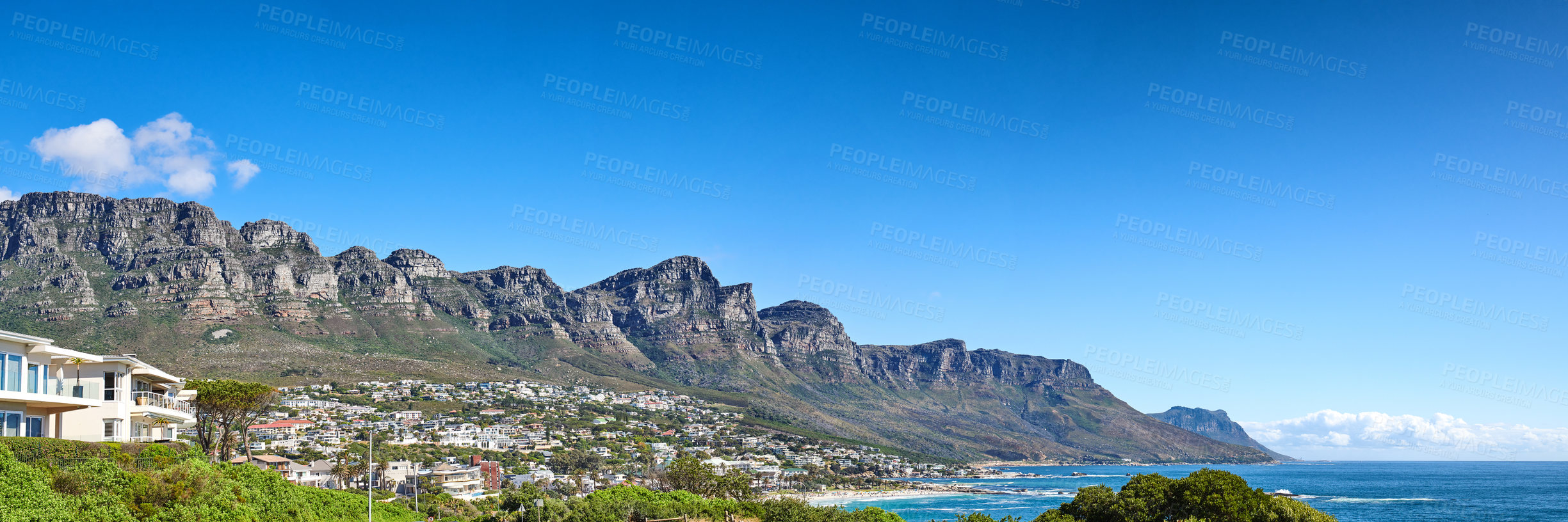 Buy stock photo Twelve Apostles at Table Mountain in Cape Town against a blue sky background along the coast. Breathtaking panoramic of a peaceful suburb surrounded by a majestic valley, scenic nature and calm sea
