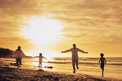 Buy stock photo Family, freedom with silhouette on beach at sunset, parents and kids running together with travel, care free and happy outdoor. Man, woman and children, ocean waves and vacation, nature and happiness