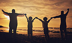 Holding hands, sunset and silhouette of a family at the beach with love, freedom and happiness. Summer, travel and back of parents with children, affection and together in the dark by the ocean