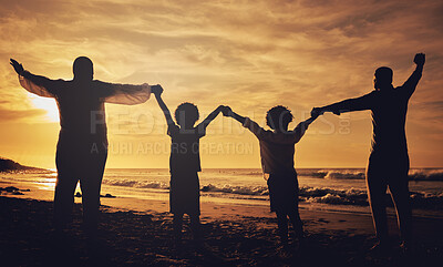 Buy stock photo Holding hands, sunset and silhouette of a family at the beach with love, freedom and happiness. Summer, travel and back of parents with children, affection and together in the dark by the ocean