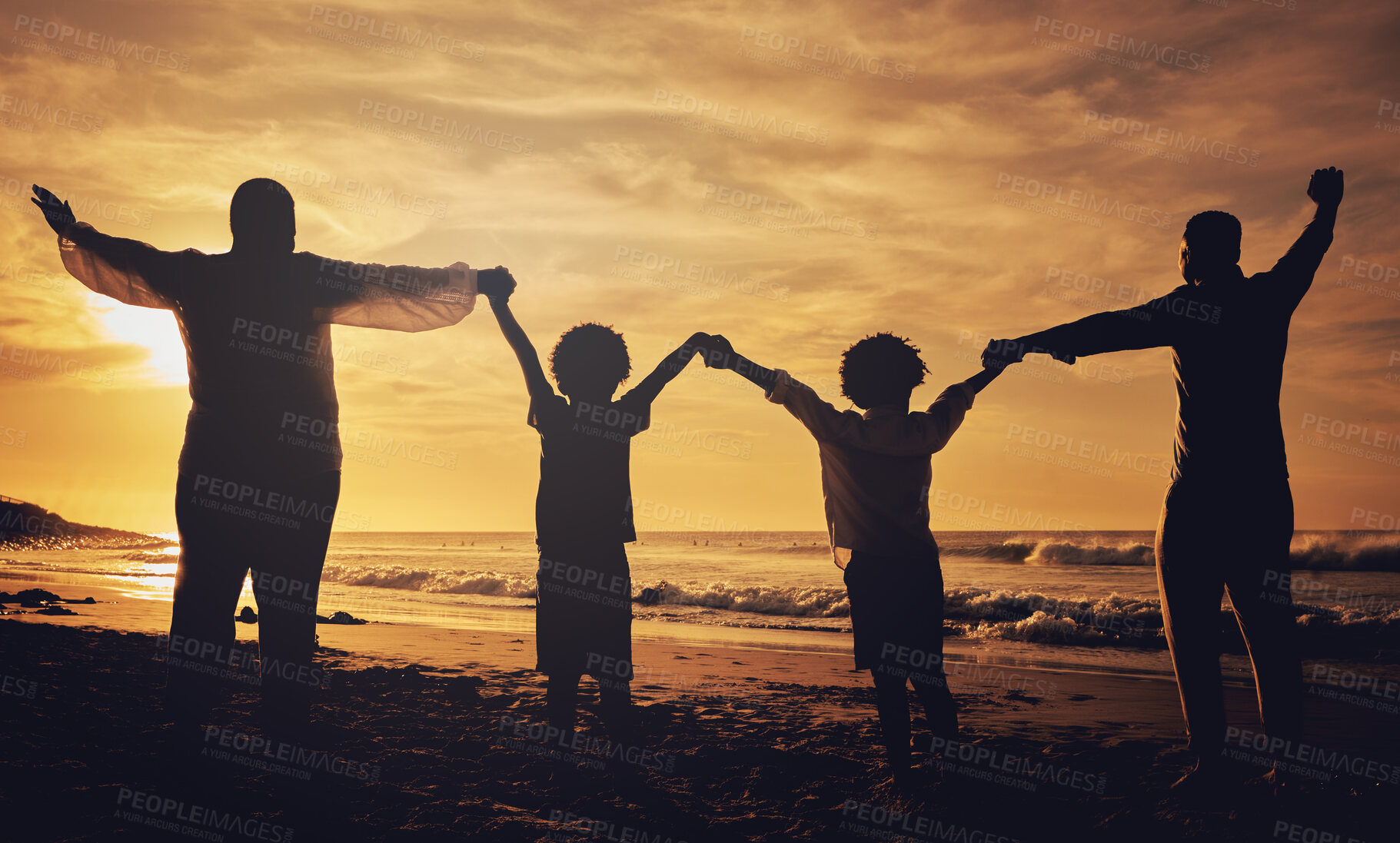 Buy stock photo Holding hands, sunset and silhouette of a family at the beach with love, freedom and happiness. Summer, travel and back of parents with children, affection and together in the dark by the ocean