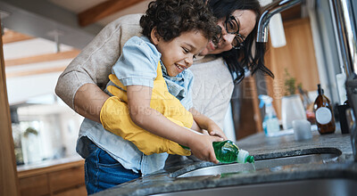 Buy stock photo Washing, dishes and mother with child in kitchen for learning housework, teaching and helping with chores. Housekeeping, happy family and mom and boy with soap for cleaning, hygiene and development