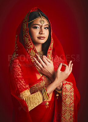 Buy stock photo Fashion, hand sign and portrait of Indian woman with veil in traditional clothes, jewellery and sari. Religion culture, beauty and female person on red background with accessory, cosmetics and makeup