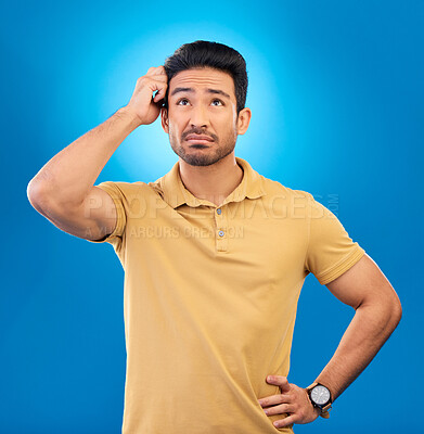 Buy stock photo Thinking, ideas and confused man brainstorming promo, problem solving plan or commercial strategy. Planning, space and studio person with questions, decision or doubt choice on blue background