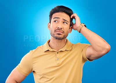 Buy stock photo Thinking, head scratch and man brainstorming solution, problem solving plan or development ideas. Studio, uncertain and confused Asian person with questions, why or doubt on blue background