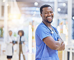 Nurse, portrait and black man with arms crossed, funny and excited in hospital. African surgeon, face and confident medical professional, happy employee or healthcare worker laughing for wellness.