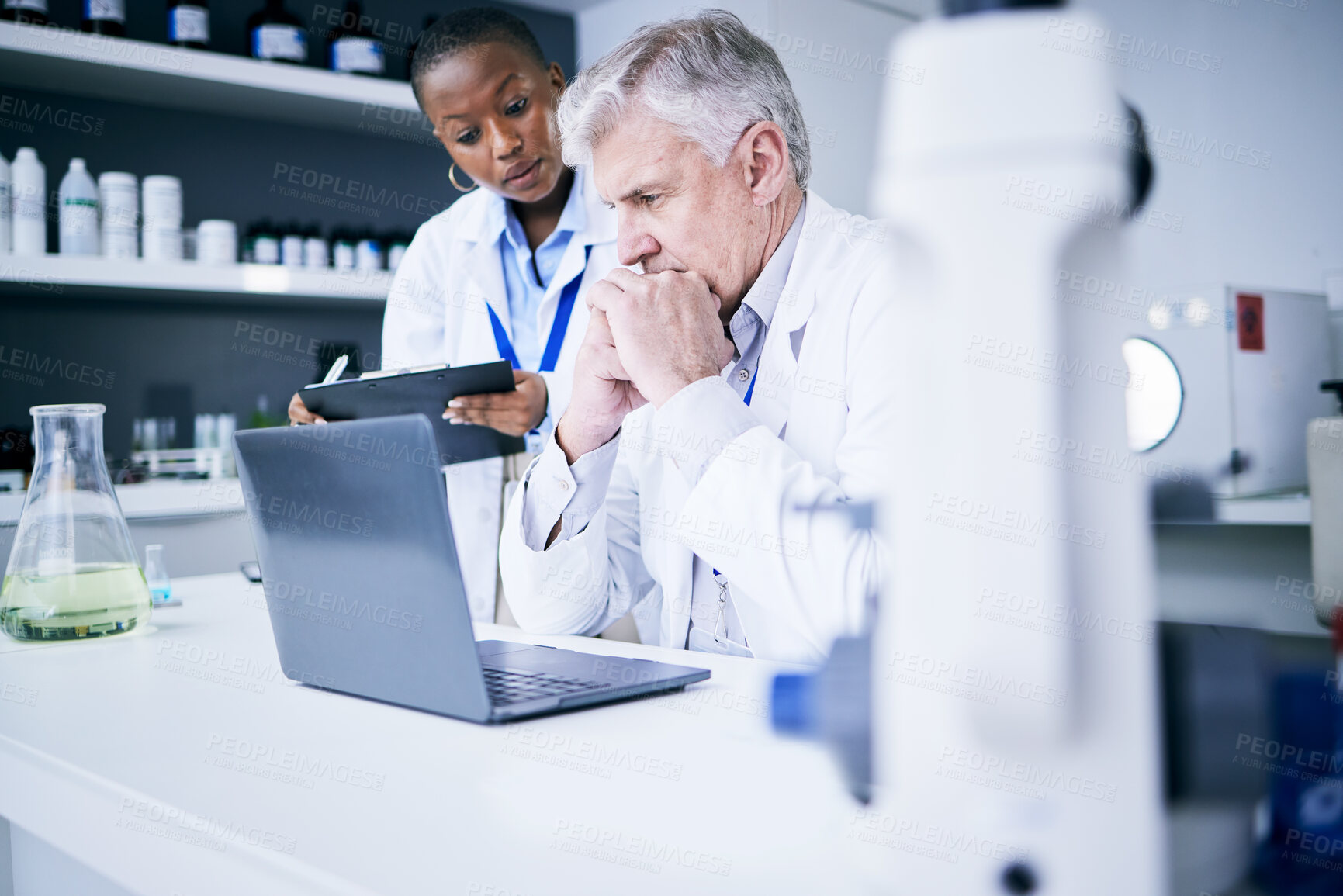 Buy stock photo Science, laptop and thinking in a laboratory for problem solving, medical research or results. Serious man and woman scientist or doctor with tech for scientific innovation, planning or teamwork