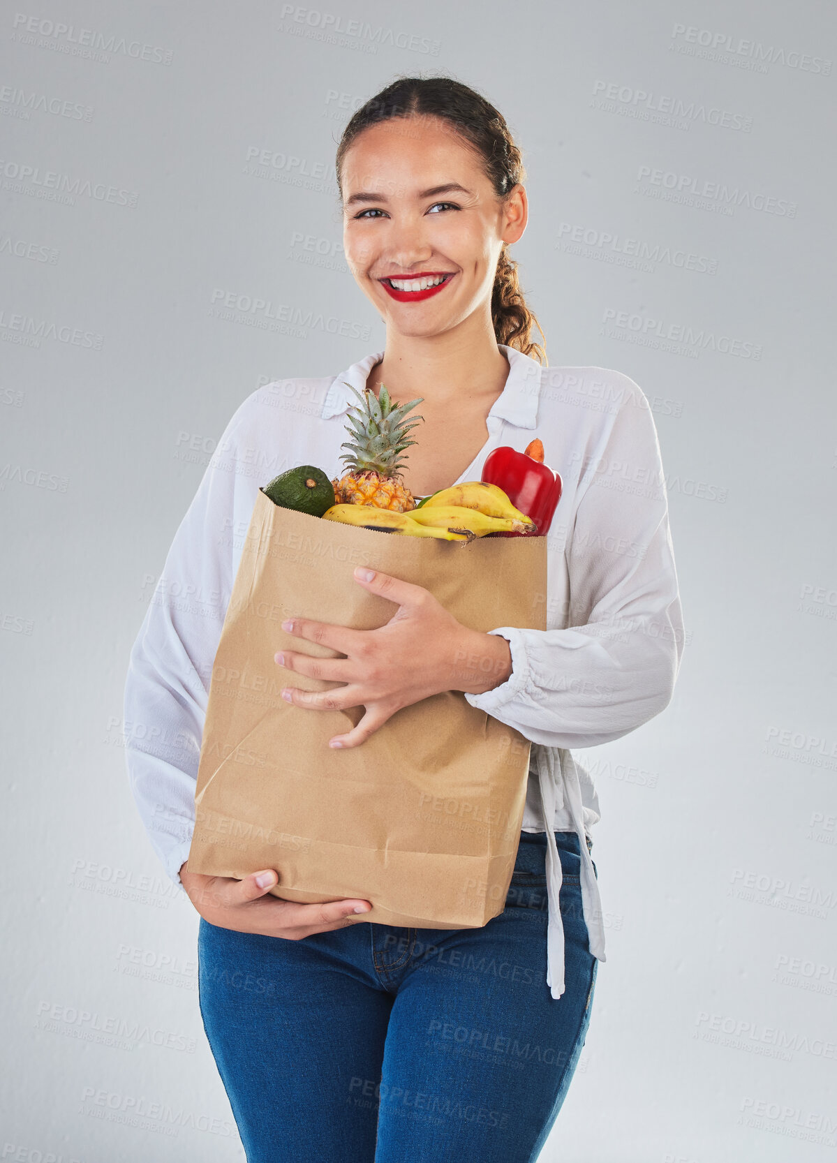 Buy stock photo Portrait, smile and woman with grocery bag, fruit and sales in studio isolated on a white background. Shopping, food and happy customer with organic vegetables for nutrition, healthy diet or wellness