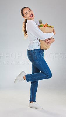 Buy stock photo Portrait, excited and woman grocery shopping for fruits on mockup space in studio isolated on white background. Sustainable bag, food and customer with vegetables for nutrition, healthy diet or sales