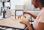 Video call, chess and woman in home with tablet, mockup and screen for gaming connection in lounge. Thinking, internet and chessboard, virtual strategy board game and African girl problem solving.
