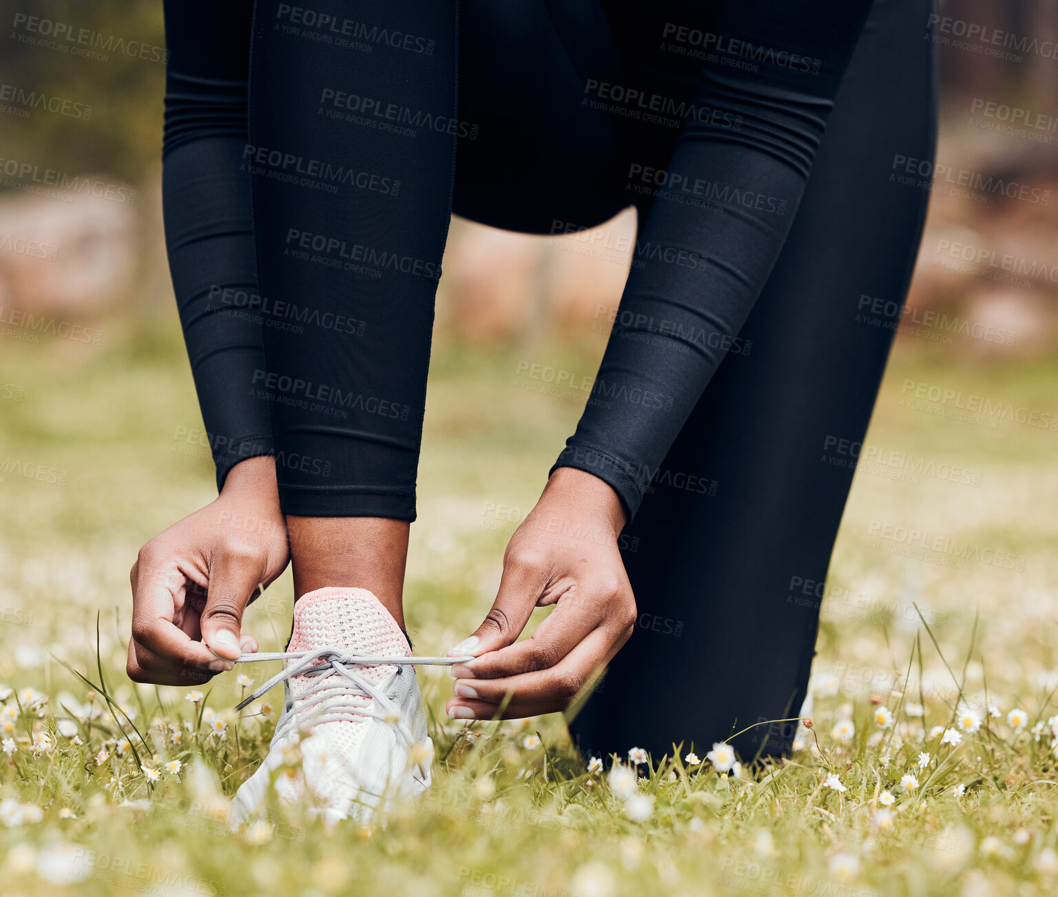 Buy stock photo Hands, person and tie sneakers outdoor on grass for running, workout and performance. Closeup of athlete, runner and lace shoes on feet, footwear and exercise at park for sports, fitness and marathon