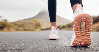 Buy stock photo Shoes, athlete and road by a mountain outdoor ready to start a run for health and wellness. Feet, person and running fitness for workout, training and exercise with sport and active on ground ashalt