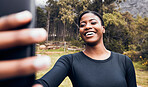 Fitness, black woman taking a selfie and in forest for social media motivation. Workout sportswear or training, exercise or health wellness and African female athlete happy with smartphone in woods