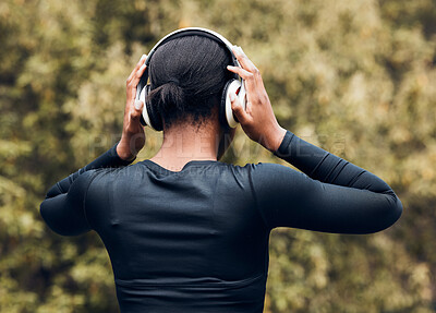 Buy stock photo Fitness, back view of woman in woods and with headphones listening to music for workout. Exercise or committed, training or focused and female athlete listen to podcast for motivation in nature