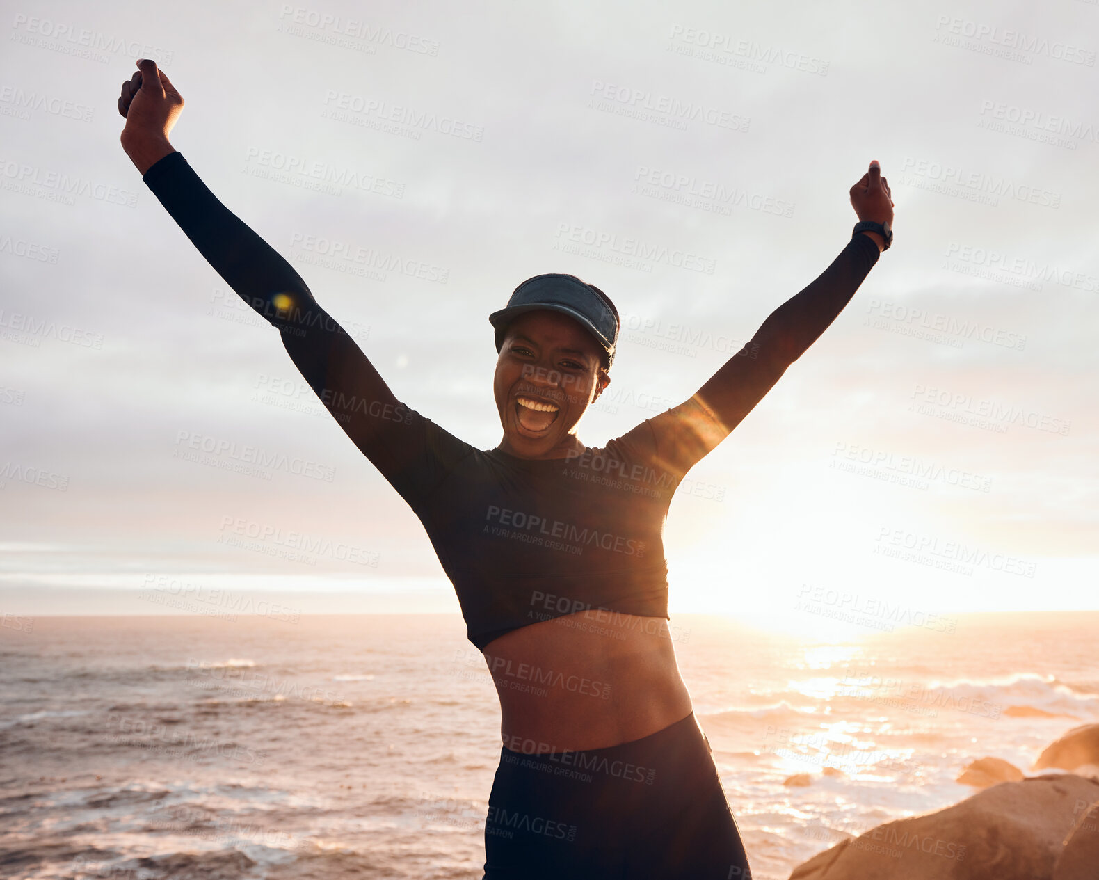 Buy stock photo Portrait of woman celebrate by ocean for fitness in nature for exercise, marathon training and running goals. Sports, sunset and female person with hands in air for winning, workout and wellness