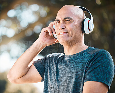 Buy stock photo Happy man, headphones and listening to music in nature for workout, training or exercise outdoors. Male person or mature runner smile with headset for audio streaming or online sound track outside