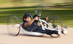 Cycling, fitness and man with disability, speed and training for competition, motivation and exercise on bike. Motion, workout and person on fast recumbent bicycle on outdoor race track for challenge