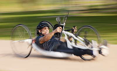 Buy stock photo Cycling, fitness and man with disability, speed and training for competition and exercise on bike. Motion blur, workout and person on fast recumbent bicycle on outdoor race track for challenge