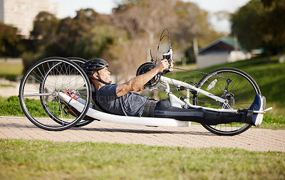 Buy stock photo Cycling, fitness and cardio with man and handcycle in nature for training, sports and challenge. Exercise, workout and marathon with person with a disability in park for wellness and health on road
