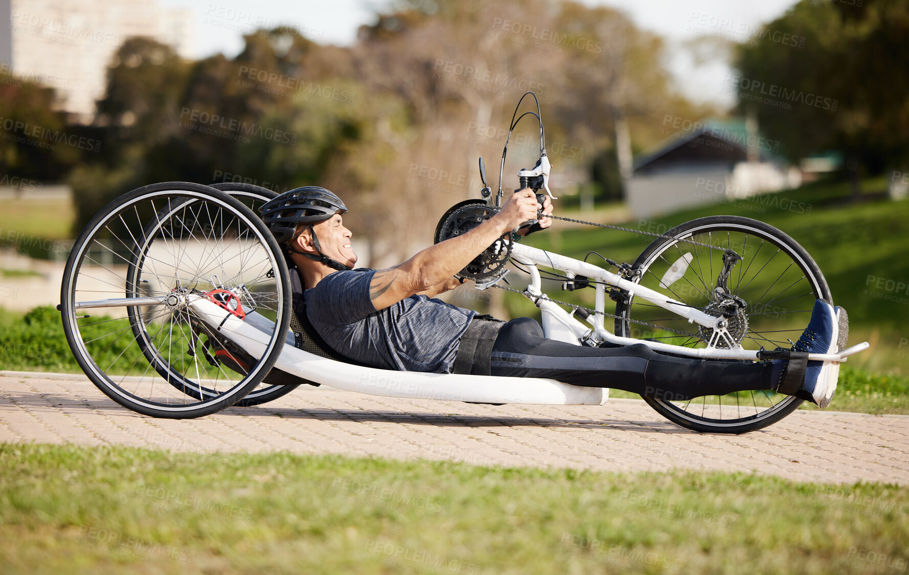 Buy stock photo Cycling, fitness and cardio with man and handcycle in nature for training, sports and challenge. Exercise, workout and marathon with person with a disability in park for wellness and health on road