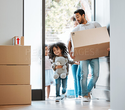 Buy stock photo Happy family, box and moving in new home for real estate, property investment or mortgage loan by door. Father, mother and children walk in house with package for relocation, renovation or start life