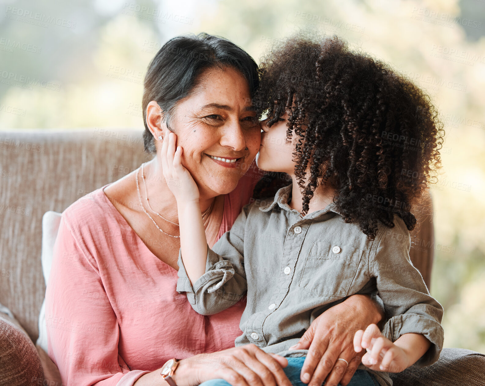 Buy stock photo Kiss, family and grandmother with child on a sofa happy, sweet and bond in their home. Love, kissing and senior woman with girl kid in living room hug, having fun and enjoying weekend together