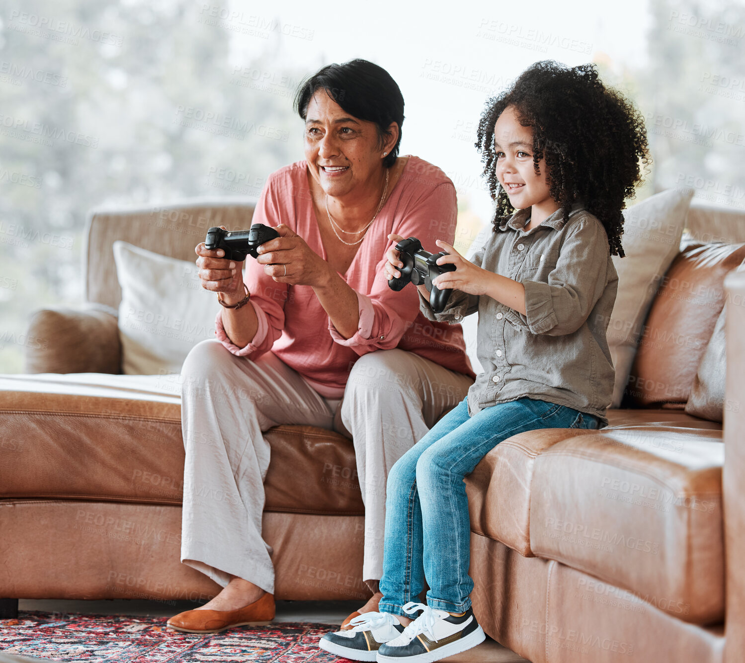 Buy stock photo Grandma, child and video game on couch, controller and happy together with bond, contest and love in lounge. Senior woman, young kid and playing with gaming, esports and competition in family house