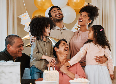 Buy stock photo Birthday, party and happy family with cake for grandmother in living room for fun, celebration and social event. Smile, surprise and grandparents, parents and kids with dessert, snacks and presents