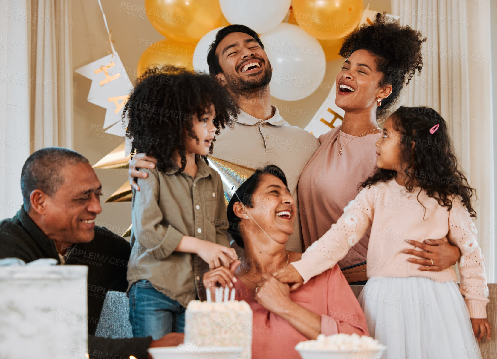 Buy stock photo Birthday, party and happy family with cake for grandmother in living room for fun, celebration and social event. Smile, surprise and grandparents, parents and kids with dessert, snacks and presents