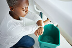 Plumbing, leak and watch with a black woman in the bathroom of her home waiting for repair assistance. Sink, emergency and time with a young female homeowner in her house to stop water using a bucket