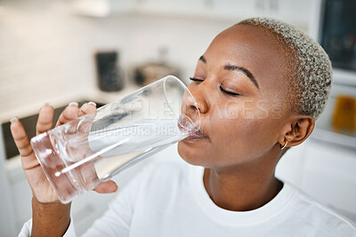 Buy stock photo Healthy, glass and woman drinking water for thirst, wellness and liquid nutrition at her home. Calm, energy and African female person enjoying cold health drink in the kitchen of her apartment.