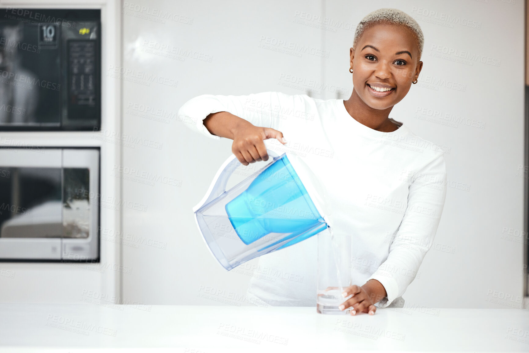 Buy stock photo Water, filter and happy woman with jug, glass and portrait in kitchen to refresh for clean liquid hydration. Smile, black female person or pouring pure aqua beverage from pitcher for healthy drinking