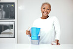 Water, filter and pitcher for woman in kitchen to refresh with glass of liquid hydration. Portrait, happy black female person or jug of pure aqua beverage for drinking cold or clean nutrition at home