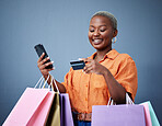 Bags, retail and black woman with a credit card, smartphone or ecommerce on a grey studio background. Female person, shopper or model with cellphone, boutique items or purchase with shopping or smile