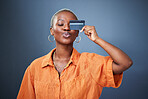 Shopping, credit card and black woman in studio for banking, savings and budget on grey background. Investment, cashback and African female satisfied with membership, payment or customer experience