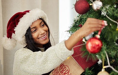 Buy stock photo Christmas, decoration or happy woman with tree in home for decor on fun holiday or vacation with smile. Relax, winter or girl hanging red ornaments or decorations for festive house party celebration