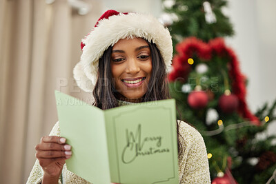 Buy stock photo Happy girl reading Christmas card, letter or note in home living room in winter holiday celebration. Smile, festive or Indian woman with emotional xmas greeting message, wishes or kind gift in house