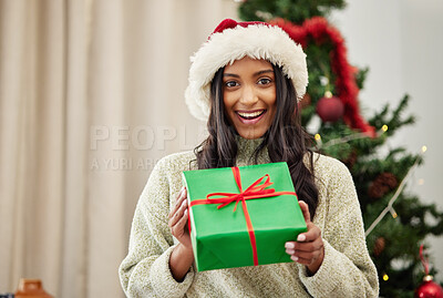 Buy stock photo Christmas, portrait or happy girl with a gift box or present on a holiday celebration at home in winter. Guessing, smile or excited Indian woman with package with festive or xmas parcel in a house 