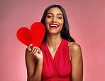 Portrait, heart and social media with a woman on a pink background in studio for love or romance. Smile, emoji and valentines day with a happy young female holding a shape or symbol of affection