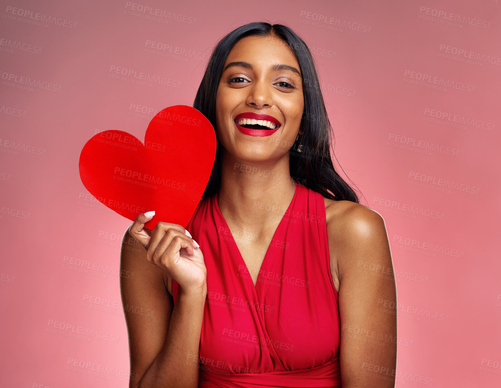 Buy stock photo Portrait, heart and social media with a woman on a pink background in studio for love or romance. Smile, emoji and valentines day with a happy young female holding a shape or symbol of affection