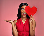 Woman, happy surprise and heart, advertising mockup in red dress and promotion of love on pink background. Valentines Day marketing, female model in lipstick and wow expression for branding in studio