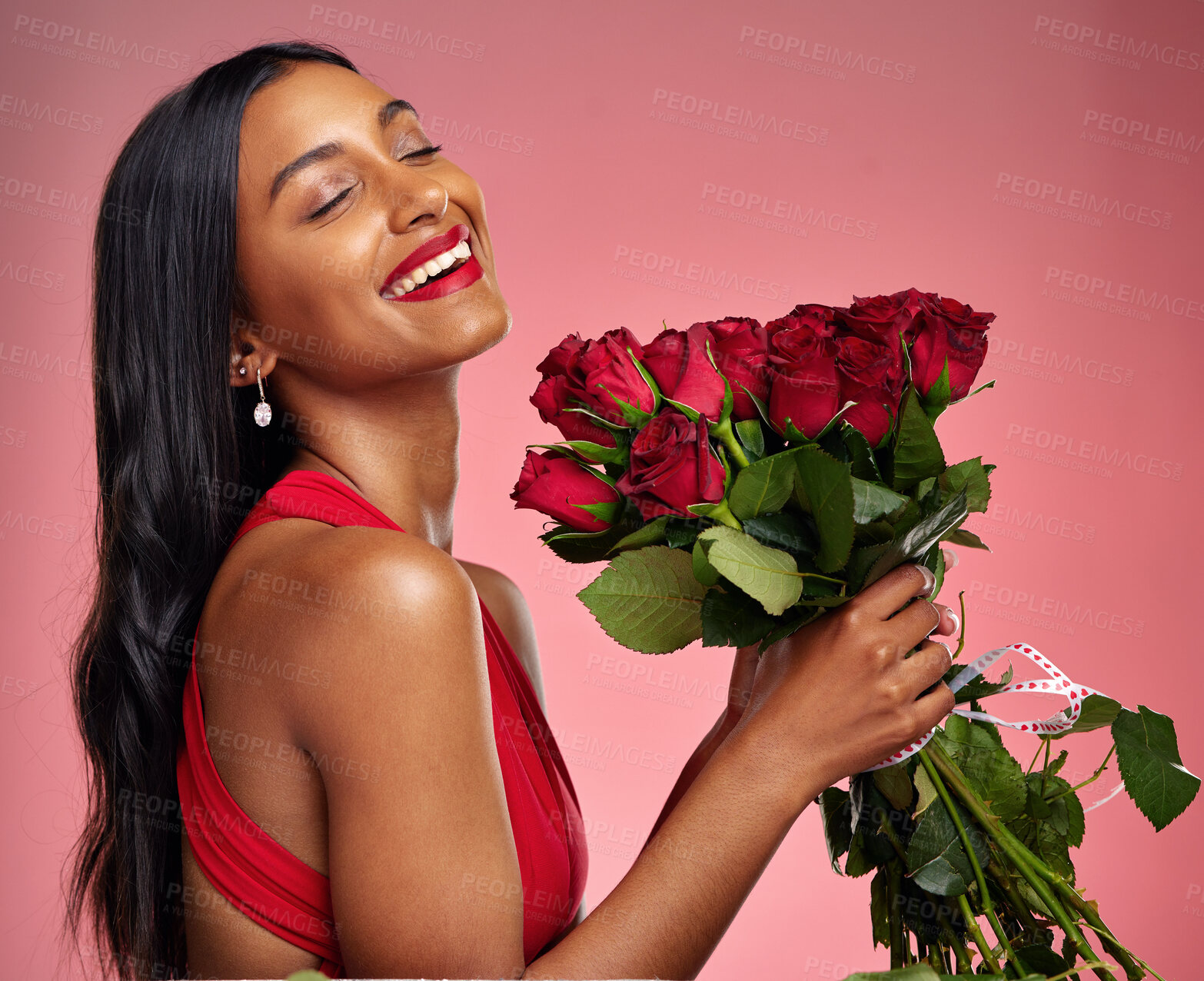 Buy stock photo Happy, beauty and face of a woman with a roses on a studio background for valentines day. Makeup, model and young Indian girl with a flower bouquet and laugh for romance or love on a pink backdrop